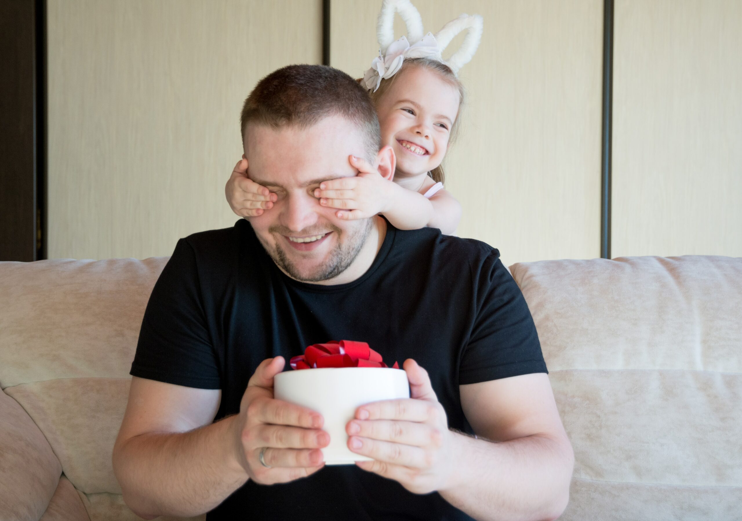 Picture of father and daughter, daughter covering the fathers eyes