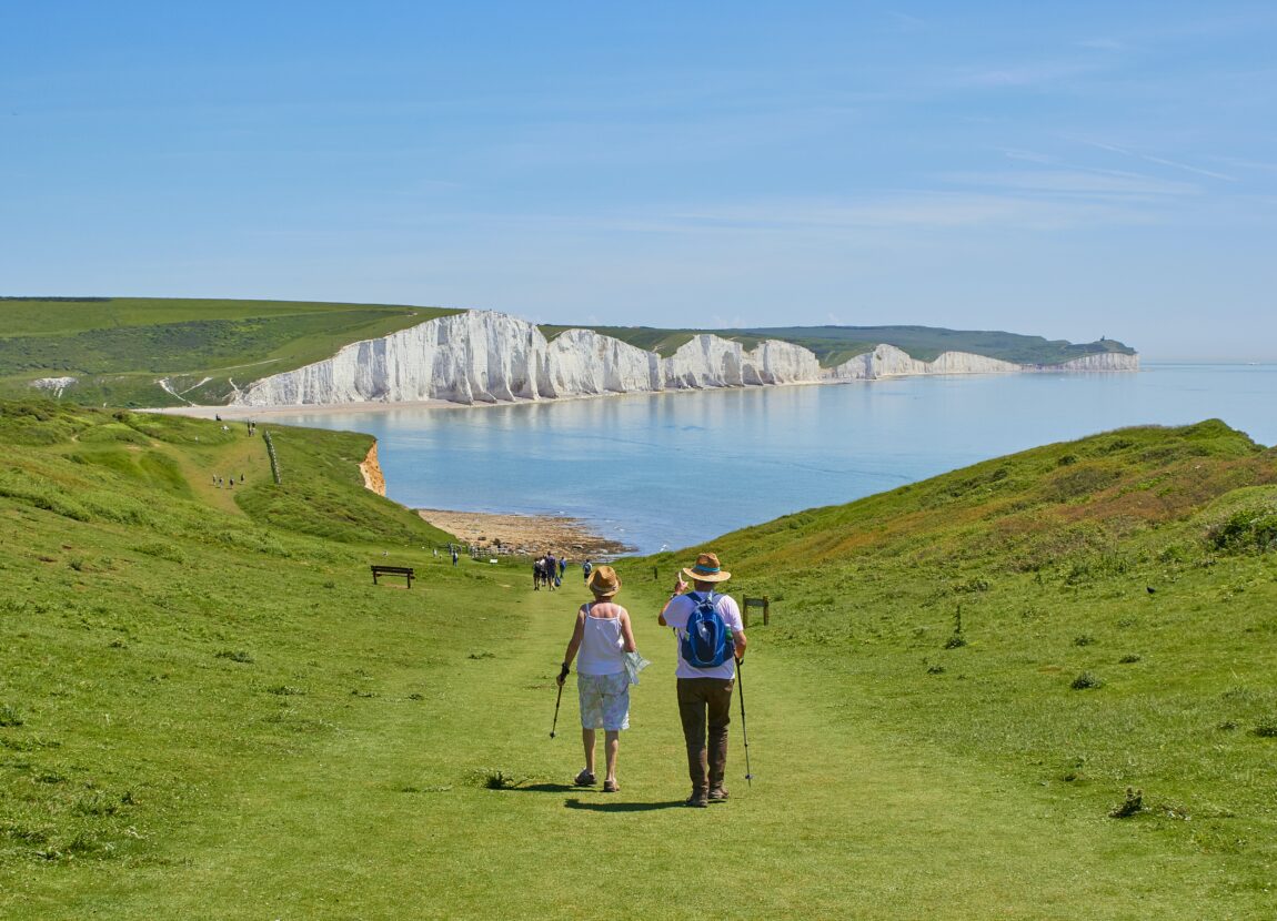 Couple walking to coast line