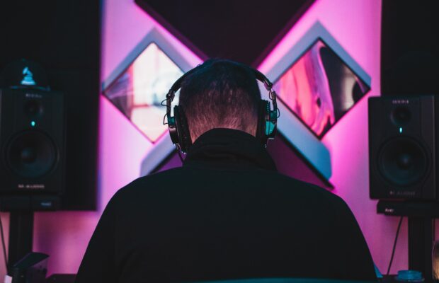 behind photo of a man in headphones