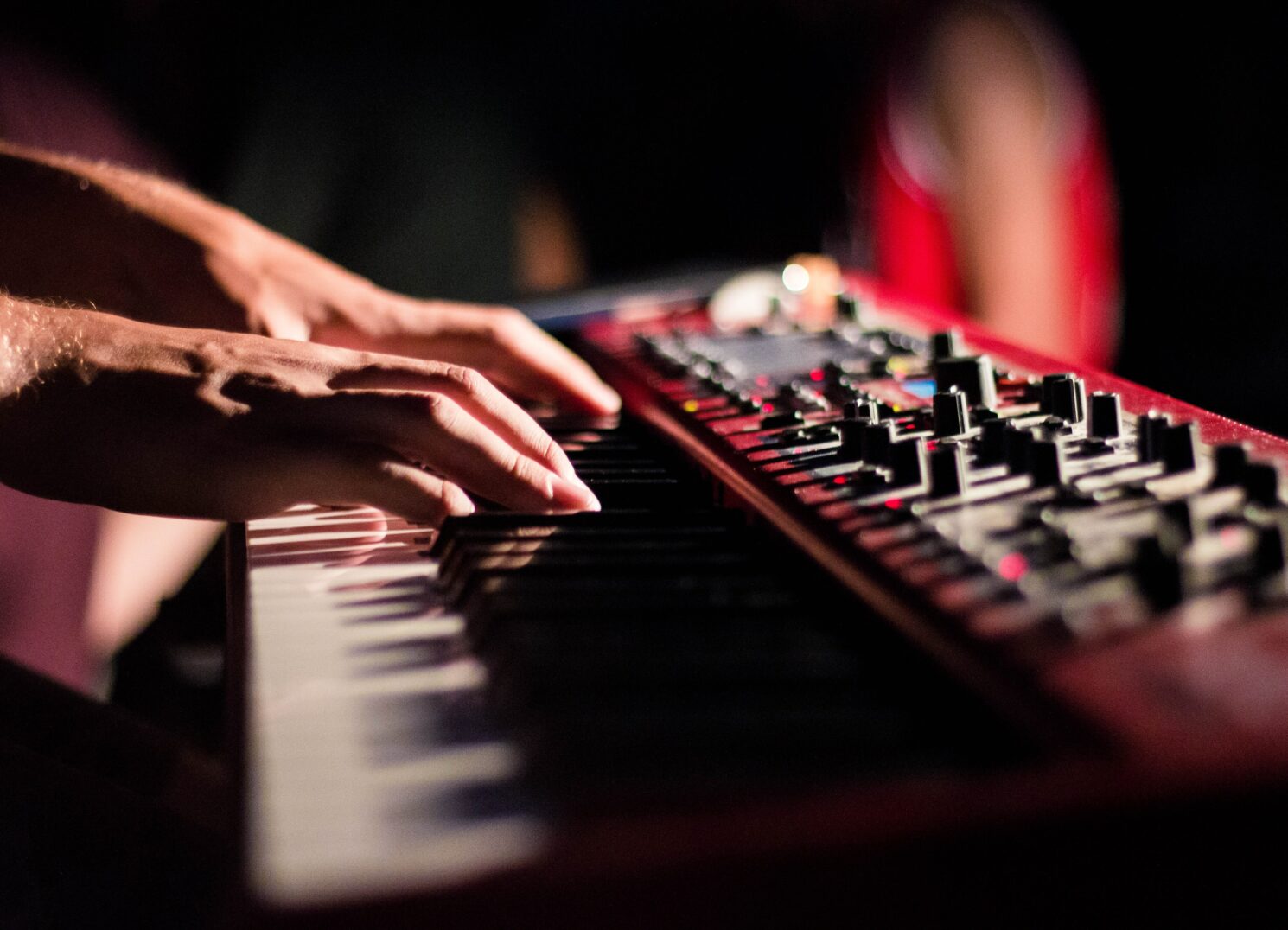 hands playing music keyboard